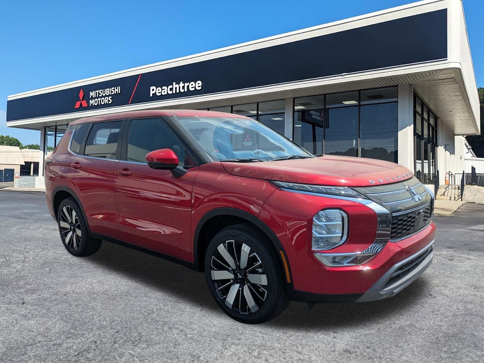 2026 Mitsubishi Outlander SE in Red Diamond — front three-quarter view
