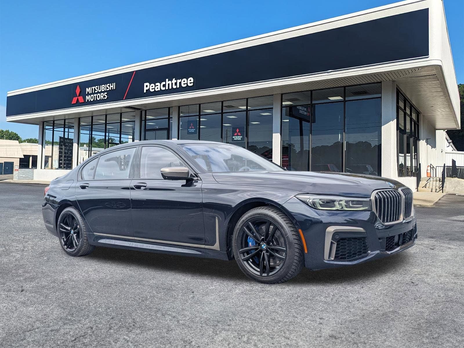 2021 BMW 7 Series M760i in Carbon Black Metallic — front three-quarter view